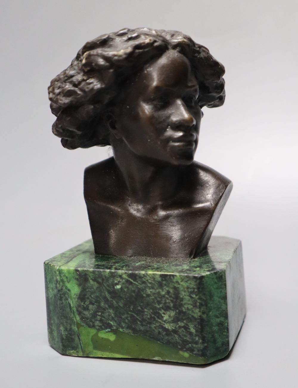 After F Masseau. A bronze bust, on green marble base